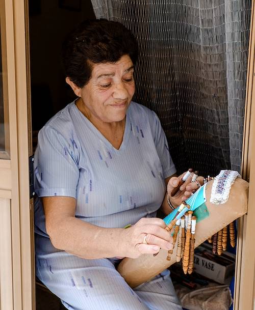 Une femme tisse une broderie traditionnelle dans une rue de la ville - Victoria - Île de Gozo - Malte