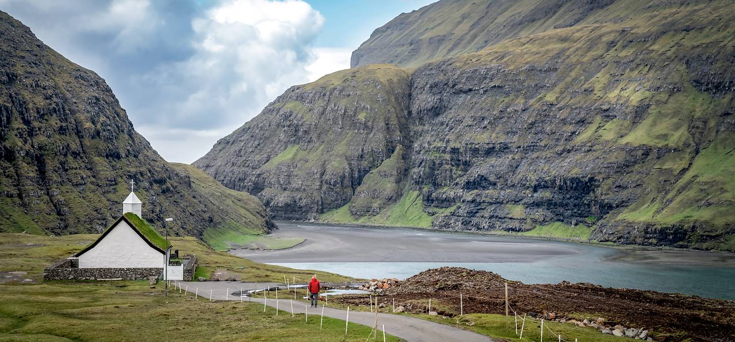 Homme marchant vers l'église du village de Saksun - Ile de Streymoy - Ile Féroé