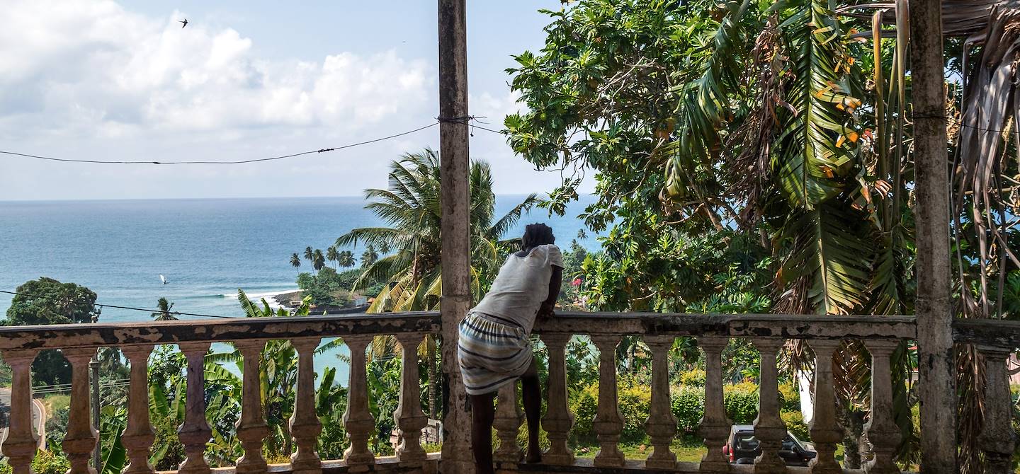 Femme regardant la mer depuis une roça- Sao Tomé-et-Principe