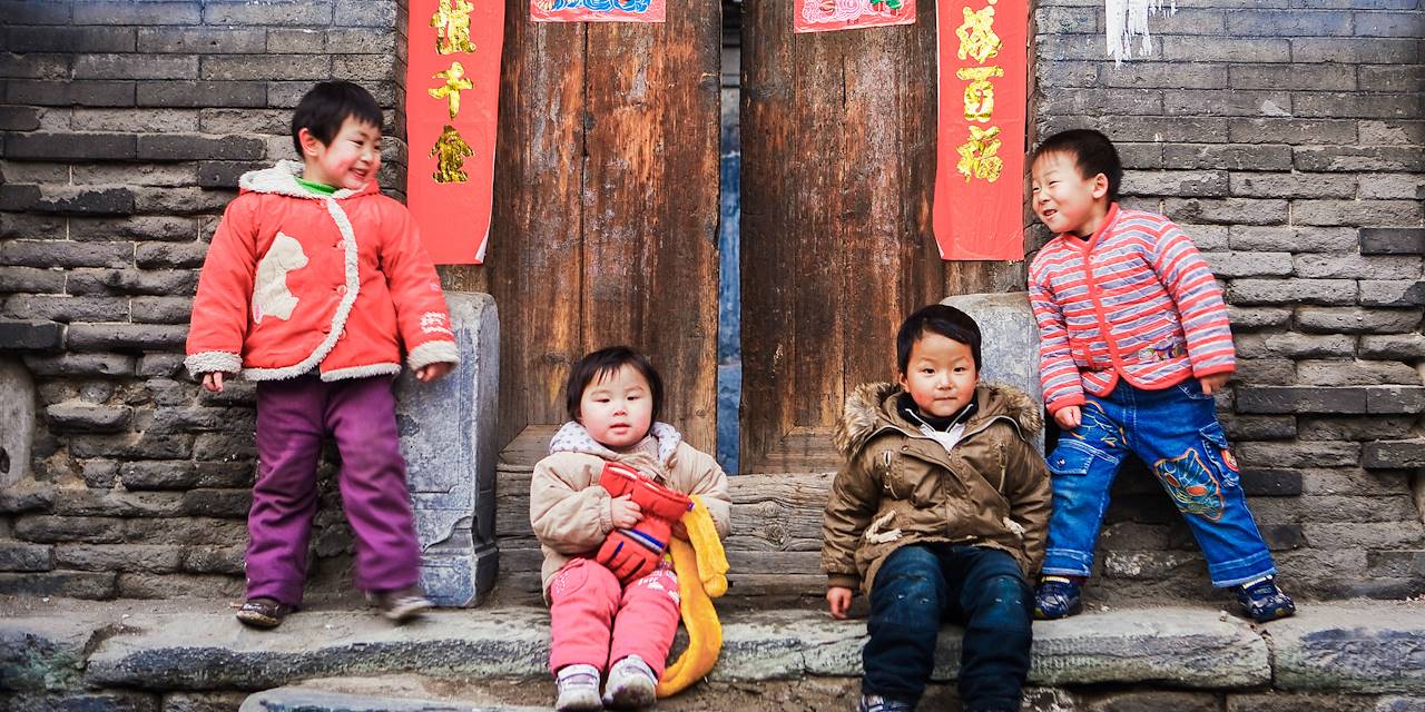 Enfants jouant devant une maison traditionnelle d'un hutong - Pékin - Chine