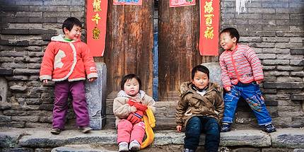 Enfants jouant devant une maison traditionnelle d'un hutong - Pékin - Chine