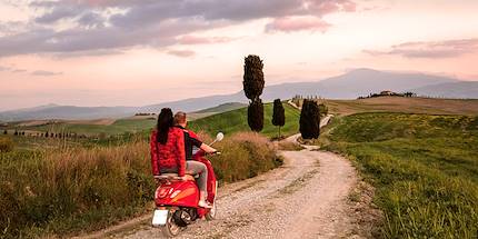 Couple en vespa au coucher du soleil - Val d'Orcia - Toscane - Italie